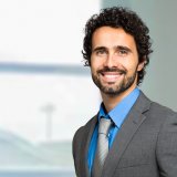 Handsome businessman at his desk in the office